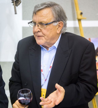 A man with a glass of wine